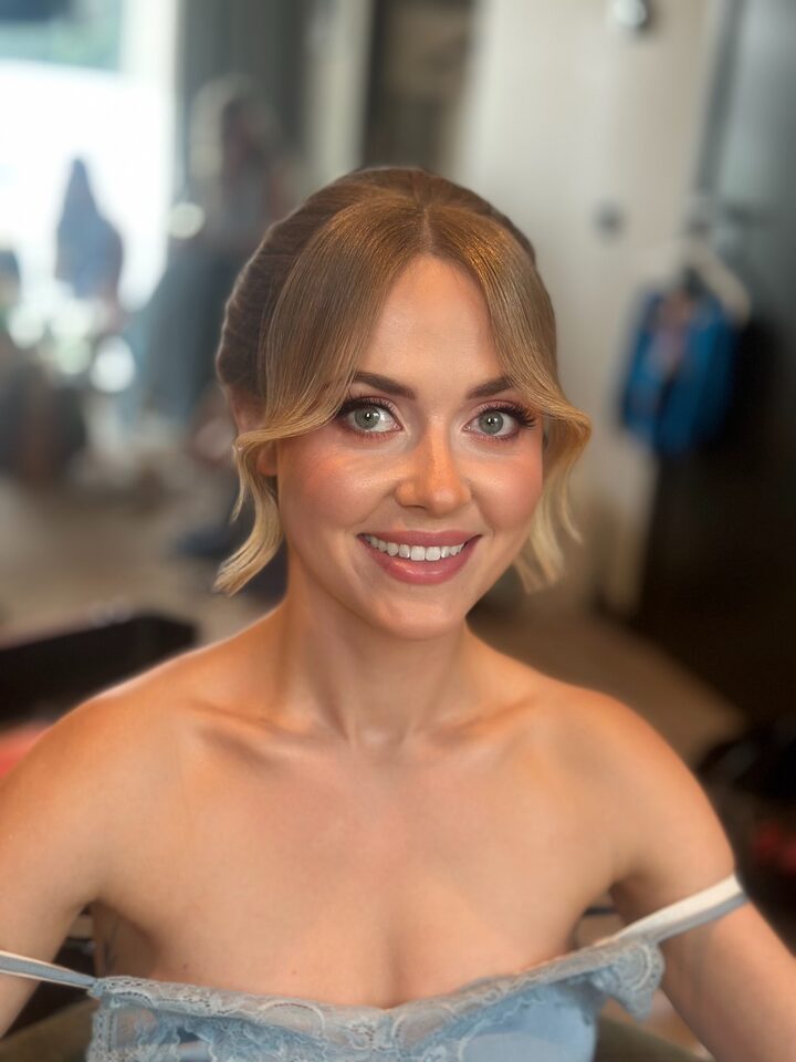 Bride with loose, wavy hair before her updo